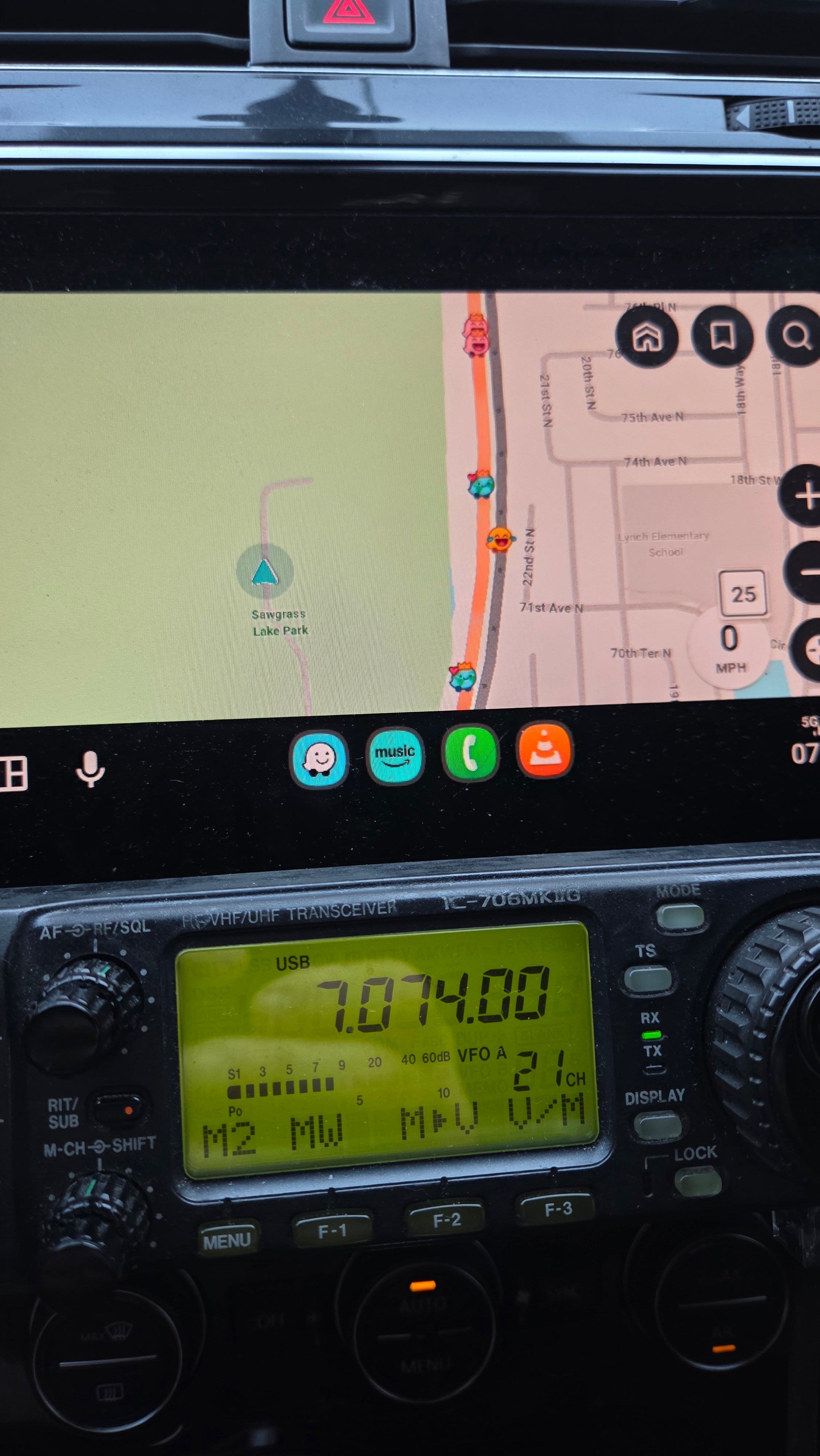 Waze navigation screen showing Sawgrass Lake Park pin on the map, with IC-706MKIIG mounted below the head unit displaying 7.074.00 MHz USB