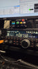 Yaesu FT-450 transceiver tuned to 14.087.50 MHz with an N7DDC ATU-100 EXT antenna tuner stacked above it, N1MM Logger+ and MMTTY visible on the monitor behind.
